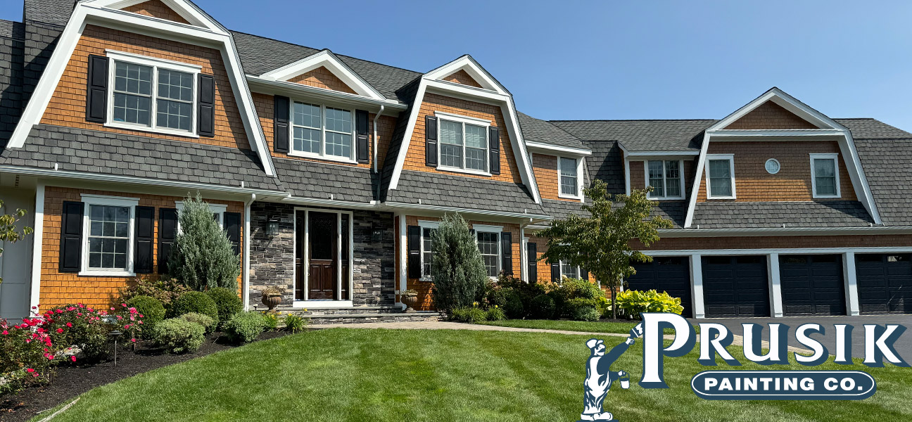 A picture of a beautiful Craftsman-style house that has painted cedar shake siding as well as traditional siding.